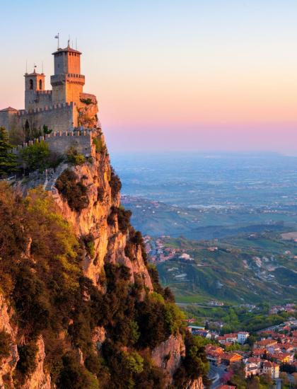 Castle on cliff at sunset, panoramic view.