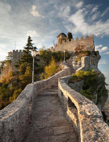 Pathway to a tower on a hill, with panoramic view.