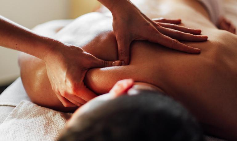 Relaxing massage on shoulders and back with expert hands.