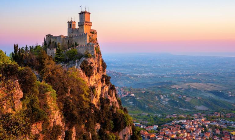 Castle on cliff at sunset, panoramic view.