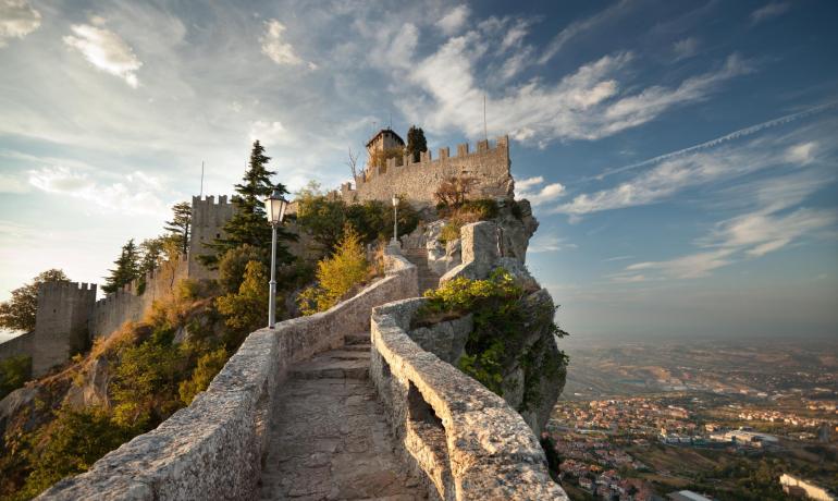 Pathway to a tower on a hill, with panoramic view.